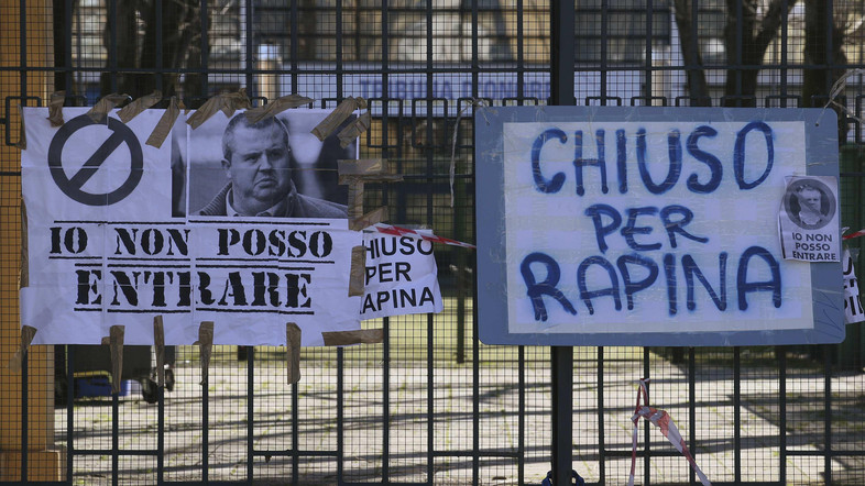 Signs with a picture of Parma soccer team's former president Tommaso Ghirardi reading "I can't go in" and "Closed for robbery"  are seen at the entrance of the Ennio Tardini stadium in Parma